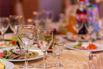 Served festive table with snacks, glasses, glasses, cutlery and napkins for a banquet