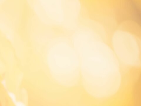 Sunlit Bokeh Glow: A Soft, Bright Abstract Background with Orange and Yellow Tones, Perfect for Summer or Christmas Illustrations