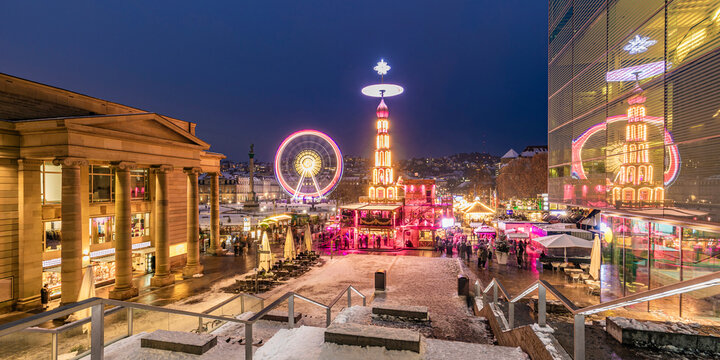 Germany, Baden-Wurttemberg, Stuttgart, Schlossplatz at winter night with Ferris wheel and Christmas market in background
