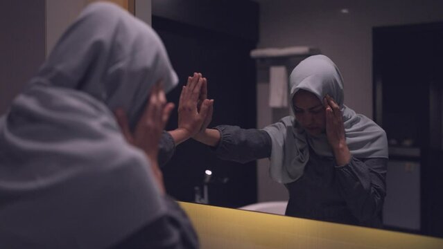A hijab-wearing woman regrets her life after falling into deep debt and being unable to make ends meet.