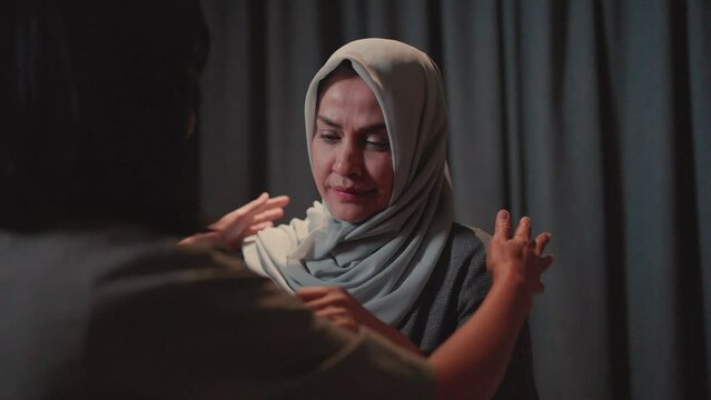 A hijab-wearing woman cries, heartbroken, and embraces gratitude for the support. show love Hope support for recovery comes soon.