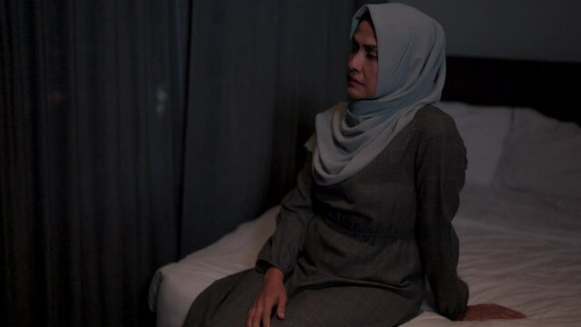 Woman wearing a hijab is thinking and feeling bad. She is depressed and not feeling well