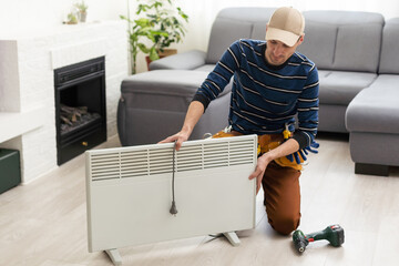 Smart heater convector. the master repairs the electric heater