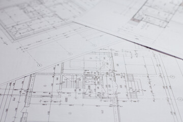 pencil and office tools for writing on the blueprint of construction industry. Place the rolls on a desk over blurred blueprint for construction industry background.