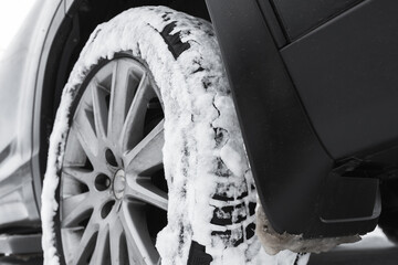 SUV car wheel on snow tire with metal studs. Close-up