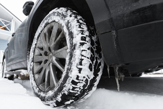 Close-up photo of a SUV car wheel on snow tire
