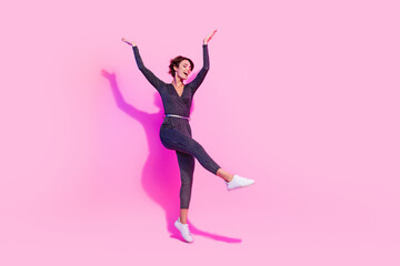 Full length photo of excited funky girl dressed glamour overall dancing having fun empty space isolated pink color background