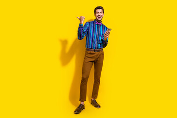Full size photo of handsome guy dressed striped shirt indicating at sale empty space hold...