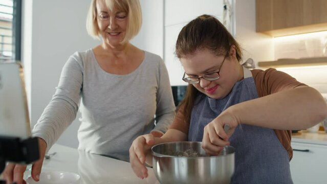 Down syndrome woman and her mother baking together. Shot with RED helium camera in 8K