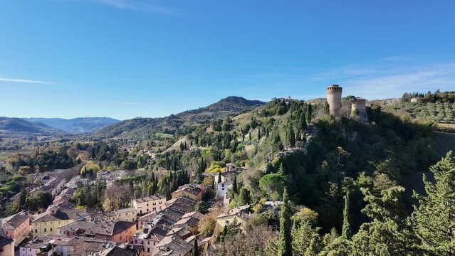 panoramic view from 19th-century Clock Tower of Brisighella village in Italy's Lamone Valley. Brisighella town skyline with Brisighella stronghold: the famous Rocca Manfrediana in Italy.
