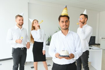 Surprise. Mixed race happy people celebrating a birthday of colleague in the modern office