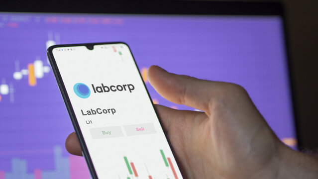 LabCorp on the screen of an exchange. LabCorp price stocks, $LH on a device.