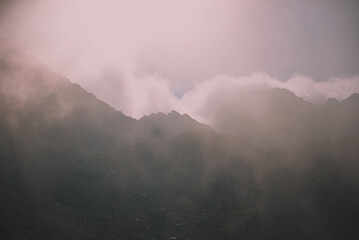 Amazing landscape in Fagaras mountains with spectacular white clouds and blue sky in Romania