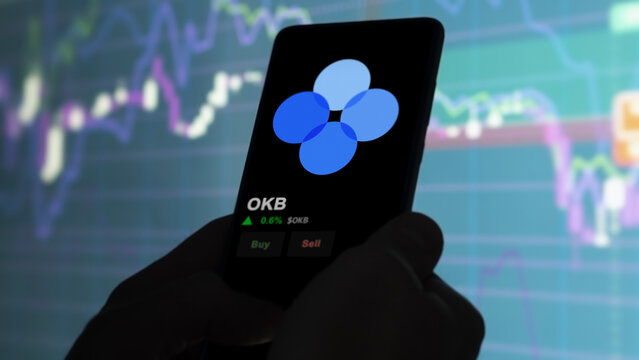 An investor analyzing the price of OKB, the token coin $OKB on a crypto exchange sreen.