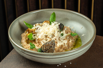 risotto with porcini mushrooms in bowl. Restaurant menu, dieting, cookbook recipe top view