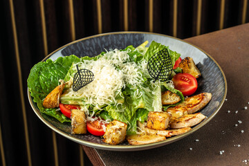 Vegetable salad with roasted turkey meat on a dark background. top view. copy space for text