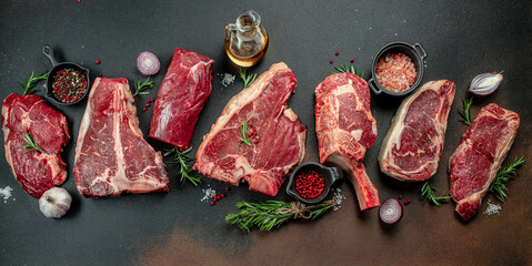 Black angus prime meat set for grilling with fresh herbs, spices. Long banner format. top view - obrazy, fototapety, plakaty