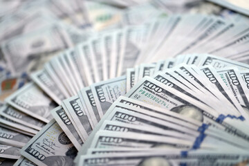 Very big amount of US hundred dollar bills close up. Huge quantity of united states currency notes on flat table