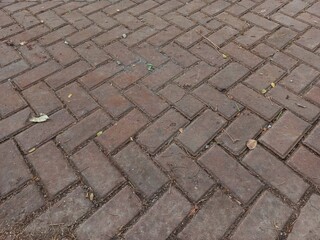 Gray paving block texture on garden path. Construction technology in variations in road structures....