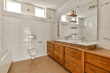 the bathroom has a large mirror and a large sink