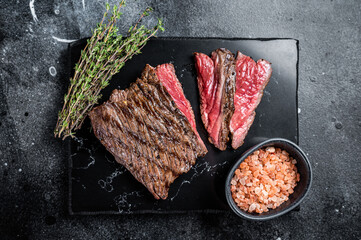 Grilled Wild Venison steak with thyme and salt, game meat. Black background. Top view