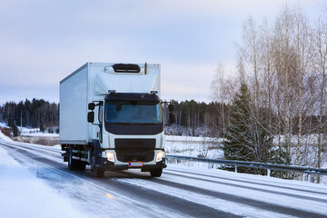 White Refrigerated Delivery Truck on Winter Road