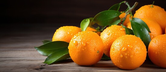 Fresh orange tangerine fruit with leaves on a wooden background