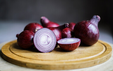 Red onions on the wooden board