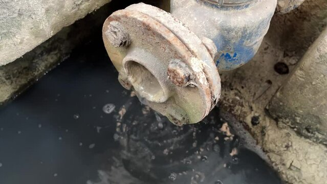 Dirty waste water coming out from pipe. Pouring water produce foam. Chemical waste water from industrial process. Wastewater Treatment Procedure (WWTP)