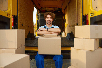 Portrait of smiling delivery man feeling satisfied due to his professional job