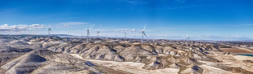 Drone panorama over a wind farm in a hilly desert landscape in Spain