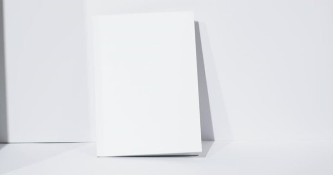 Video of book with blank white pages and copy space on white background
