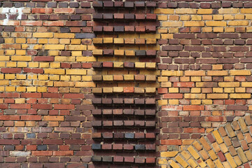Old red brick wall with protruding blocks as background