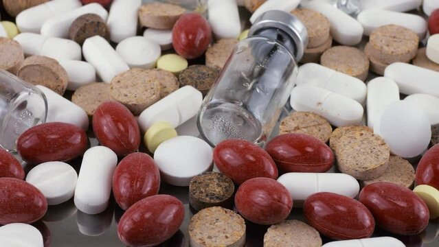 Pharmacy background on a metal surface. Tablets, pills, glass flacons and ampoule. Medicine and healthy. Close up of capsules.