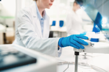 laboratory technician in lab coat and gloves performs series of tests  in bio laboratory. Doctor...