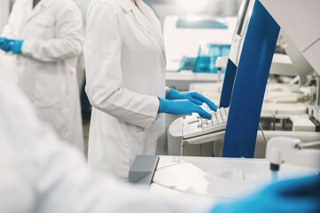 laboratory technician in lab coat and gloves performs series of tests  in bio laboratory. Doctor...