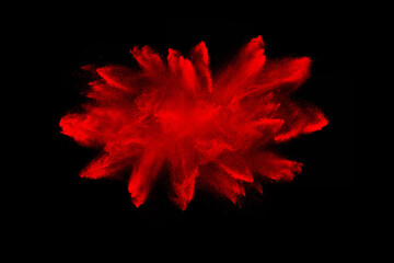 red powder explosion on black background. Colored cloud. Color dust explode. Paint Holi