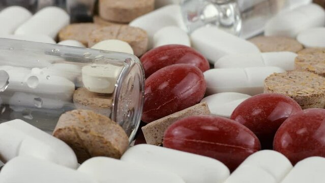Pharmacy background on a metal surface. Tablets, pills, glass flacons and ampoule. Medicine and healthy. Close up of capsules.