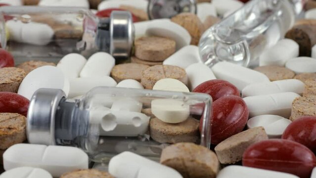 Pharmacy background on a metal surface. Tablets, pills, glass flacons and ampoule. Medicine and healthy. Close up of capsules.