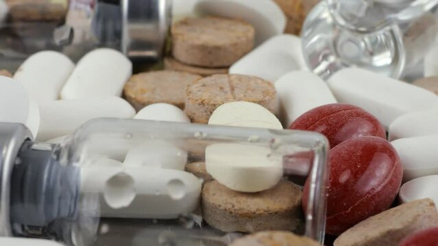 Pharmacy background on a metal surface. Tablets, pills, glass flacons and ampoule. Medicine and healthy. Close up of capsules.