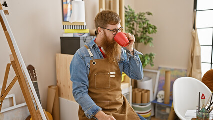 Irish redhead young guy, the handsome indoor artist, a day in his life drinking coffee in a...