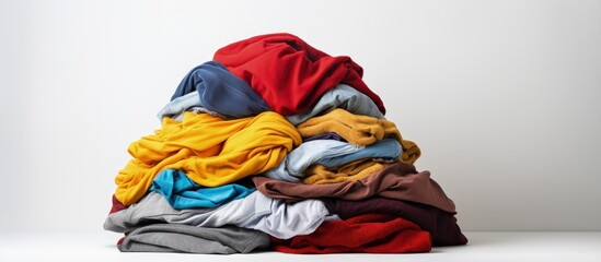 Clothes stacked on a white surface Copy space image Place for adding text or design