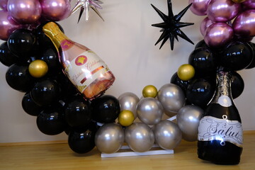 Birthday party with balloons for an adult. Black balloons and wine bottle shaped balloon