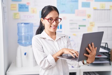 Young beautiful hispanic woman business worker using laptop working at office