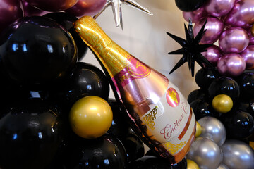 Birthday party with balloons for an adult. Black balloons and wine bottle shaped balloon