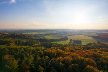 Fototapeta na wymiar Serene autumnal panorama, european village, fields, and forest from a drone's eye view