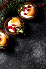 Christmas nut tartlets. Delicious, beautiful cupcakes are decorated with Christmas garlands and Christmas tree branches. Selective focus. Copy space