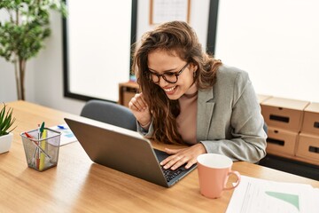 Young beautiful hispanic woman business worker having video call at office