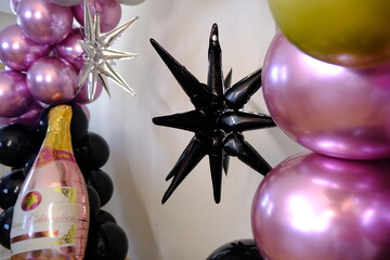 Birthday party with balloons for an adult. Black balloons and wine bottle shaped balloon