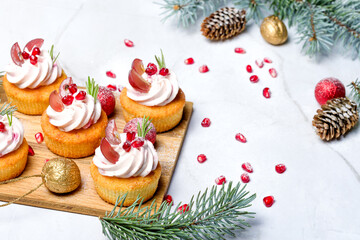 Traditional Christmas cottage cheese cupcakes. Decorated with fir branches and Christmas decorations. Copy space. High key